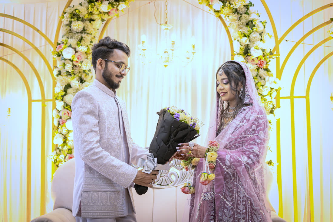 Tousif handing Lubna a bouquet