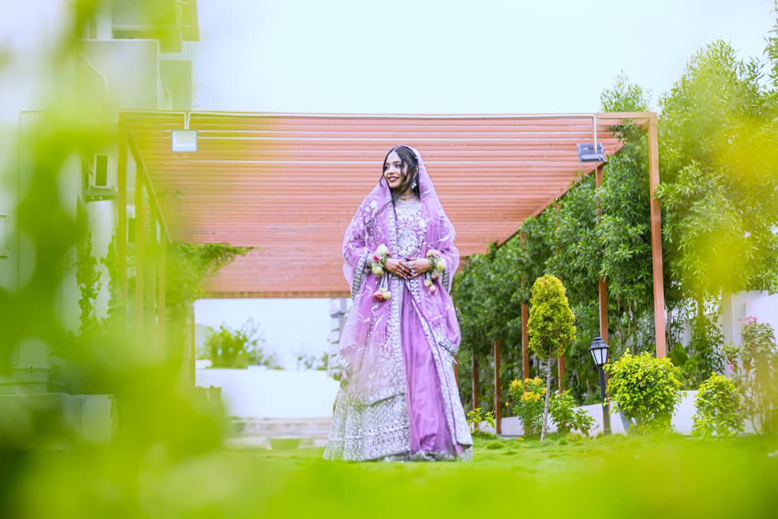 Lubna walking through the pergola