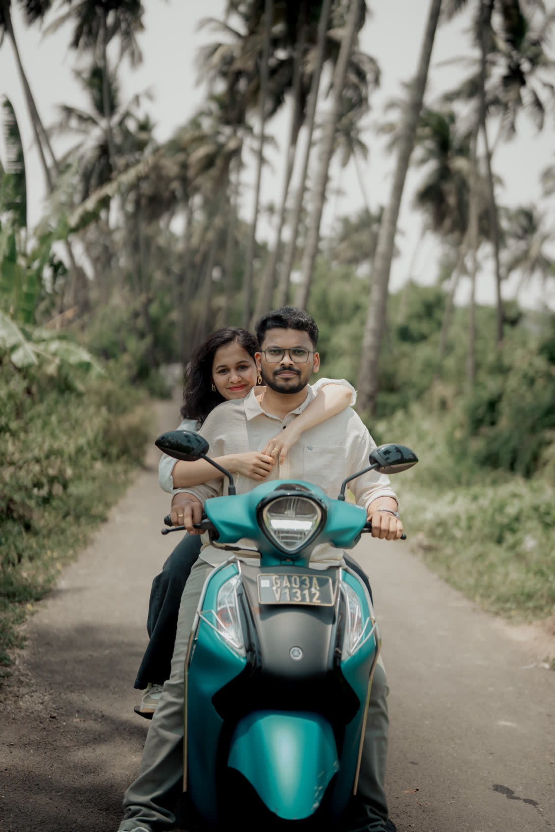 Rakshita and Rahul with a scooter