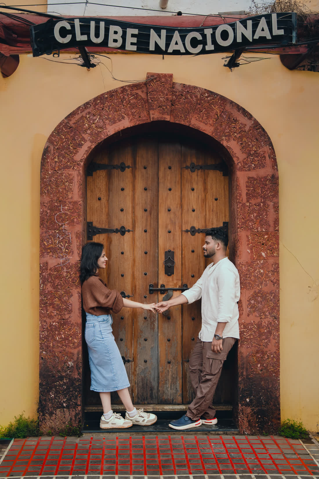 Rakshita and Rahul by a wooden door